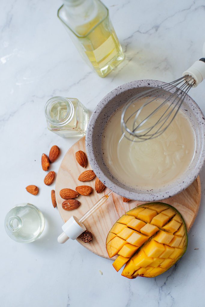 mixing ingredients for DIY body butter with mango and almond oil